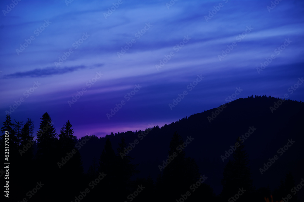 Night in mountains. Silhouette against the sky