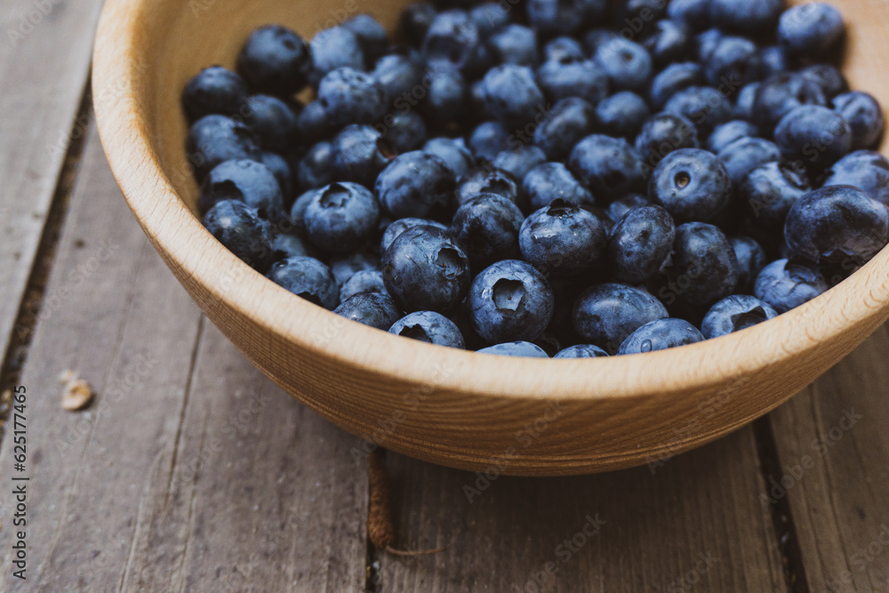 Depevyanaya bowl with ripe large blueberries. Top view composition. Depevyanaya bowl with ripe large blueberries. Top view composition.