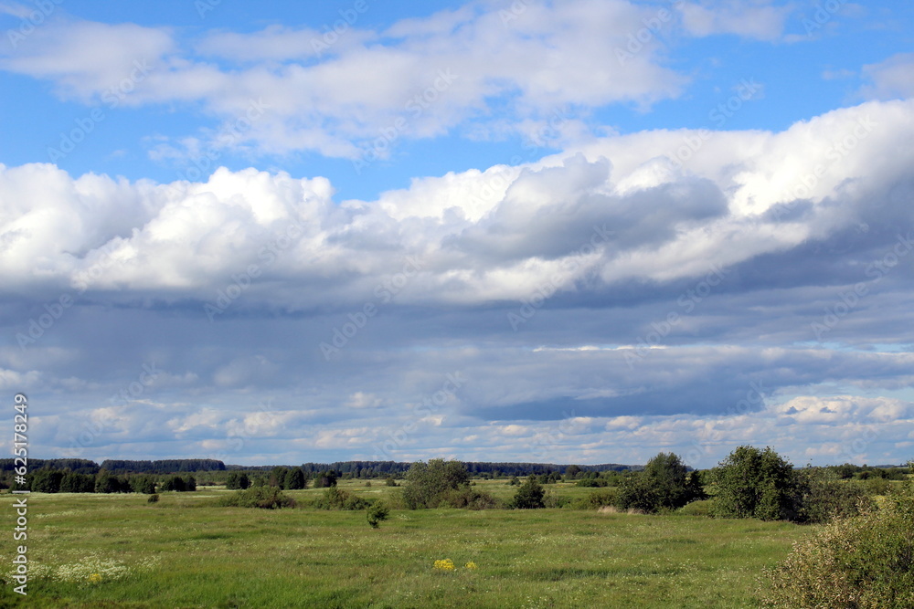 Summer landscape of beautiful nature with clouds and trees.