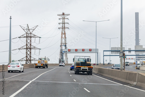 Trucks and cars on road in Docklands, Melbourne, Victoria about to cross Blote Bridge photo