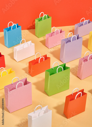 A pattern of colorful shopping bags on a table. Idea of weekend shopping.
