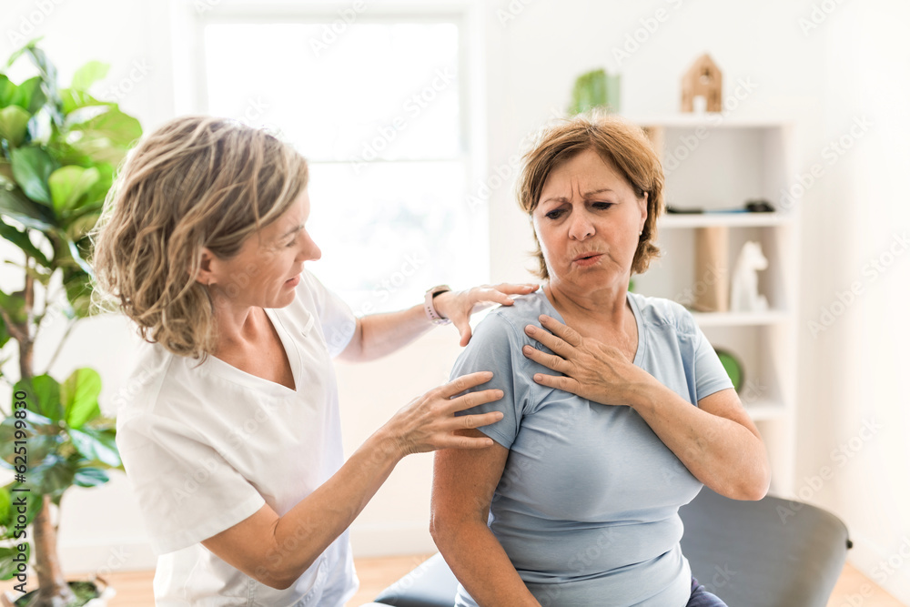 Physiotherapist working with elderly patient in clinic Physiotherapist working with elderly patient in clinic