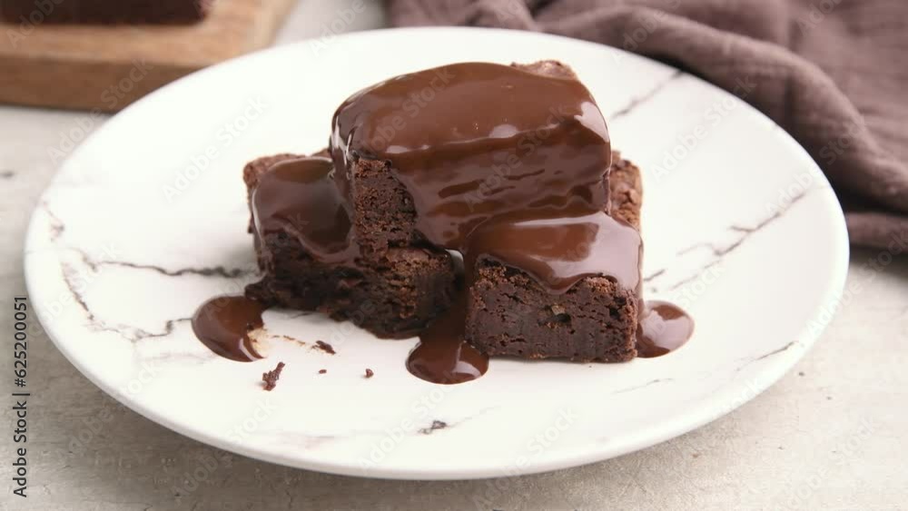 Hand picking a piece of brownie on a plate Hand picking a piece of brownie on a plate