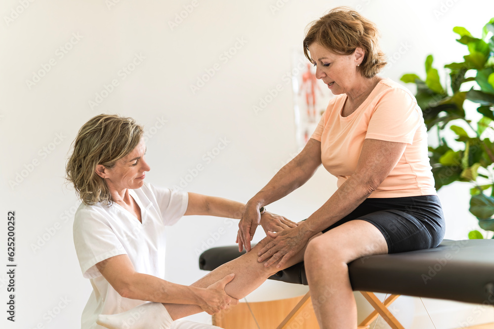 Physiotherapist working with elderly patient in clinic Physiotherapist working with elderly patient in clinic