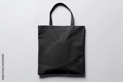 Mockup of a black canvas tote bag with a white background.