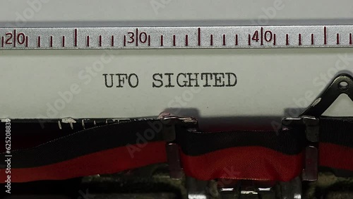 Sighting a UFO unidentified flying object. Zoom and turn in to typing UFO SIGHTED on an old manual typewriter.