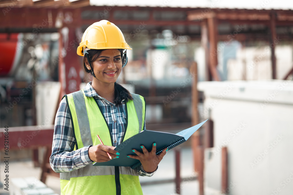Portrait Asian indian female professional Engineer factory. Engineering worker in safety hardhat at factory industrial facilities. Heavy Industry Manufacturing Factory. Prefabricated concrete walls - obrazy, fototapety, plakaty 