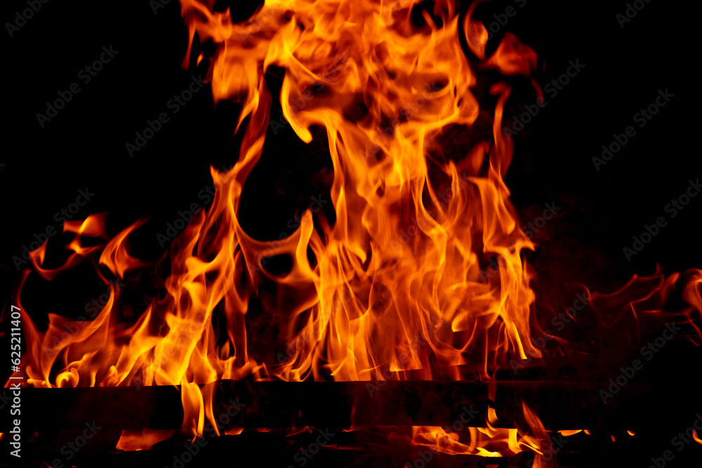Fototapeta premium Fire flame burning and glowing on dark black background