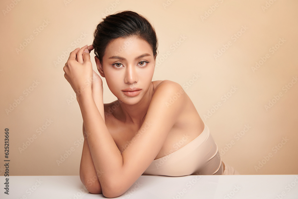 Beautiful young asian woman with clean fresh skin on beige background, Face care, Facial treatment, Cosmetology, beauty and spa, Asian women portrait. Beautiful young asian woman with clean fresh skin on beige background, Face care, Facial treatment, Cosmetology, beauty and spa, Asian women portrait.