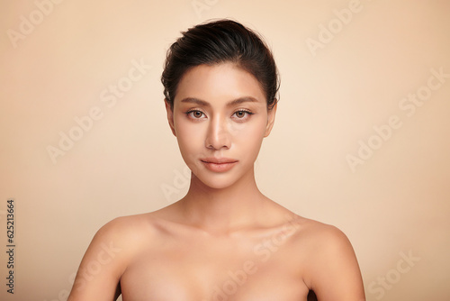 Beautiful young asian woman with clean fresh skin on beige background, Face care, Facial treatment, Cosmetology, beauty and spa, Asian women portrait.