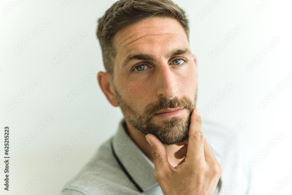 Close-up daylight portrait of young smiling handsome man isolated on gray background Close-up daylight portrait of young smiling handsome man isolated on gray background