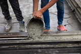man pouring concrete slab. Asian Engineer man working at precast factory. Engineering worker in safety hardhat at factory industrial facilities. Heavy Industry Manufacturing Factory