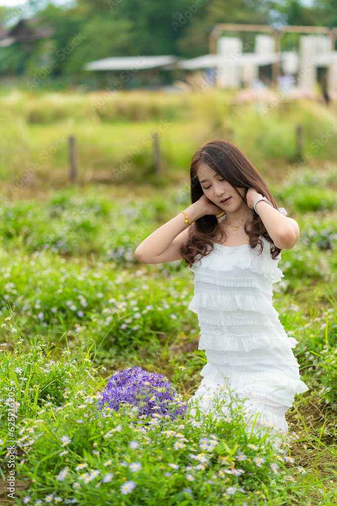 Young Asian woman traveling in a colorful flower garden in Chiang Mai, Thailand. Young Asian woman traveling in a colorful flower garden in Chiang Mai, Thailand.