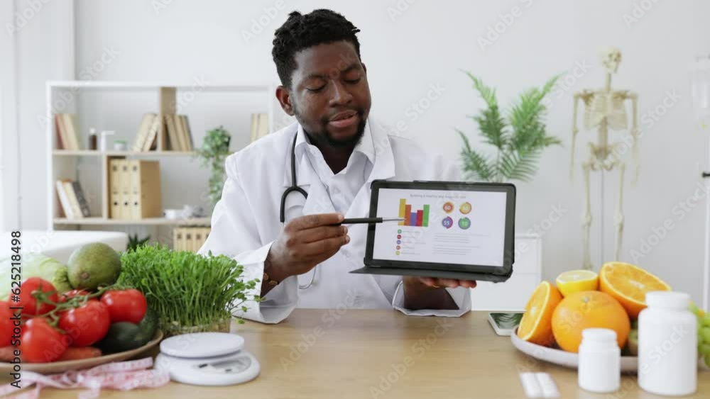 Male expert in dieting posing on camera with digital tablet and demonstrating scale of obesity among people with improper nutrition. Afican american professional offering courses for weight loss. Male expert in dieting posing on camera with digital tablet and demonstrating scale of obesity among people with improper nutrition. Afican american professional offering courses for weight loss.
