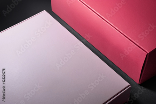 Close-up of a Packaging paper box of pink colors on gray background photo