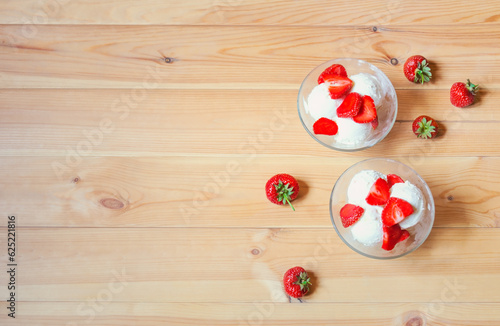 Sundae ice cream with strawberry slices. Top view, copy space.