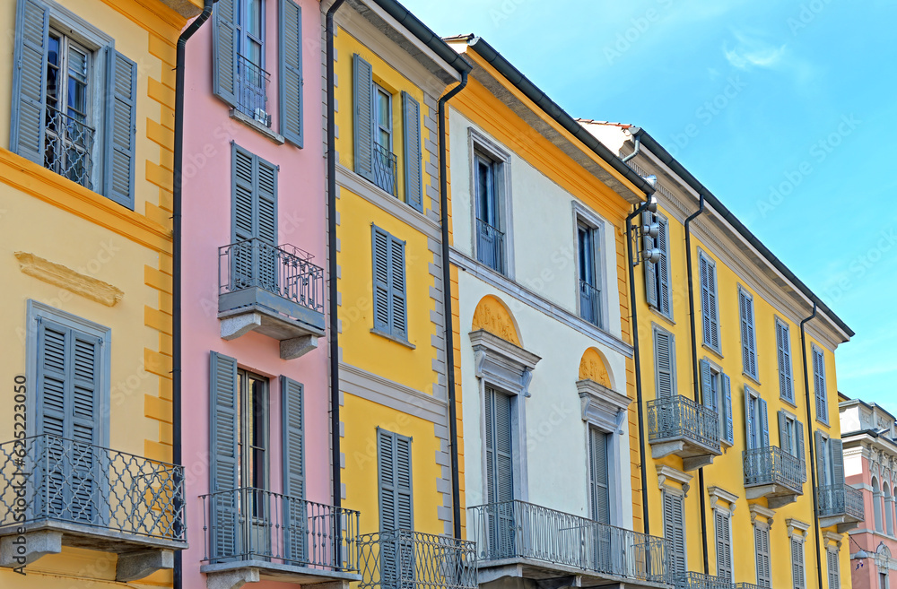 Typical ancient colorful houses with wrought iron balcony in the centre of Lodi, Lombardy, Italy on a bright spring day