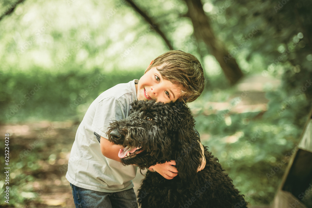 boy with a goldendoodle dog in the park boy with a goldendoodle dog in the park