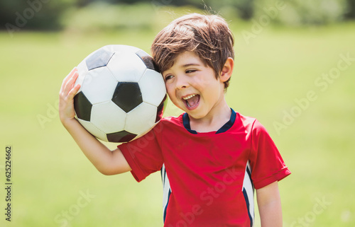 Young soccer player having fun on a field with ball © Louis-Photo