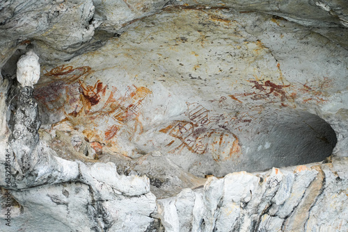 Khao Khian prehistoric cave painting in an overhanging cavity of a limestone karst cliff in the Bay of Phang Nga in the Andaman Sea in Thailand, Southeast Asia photo