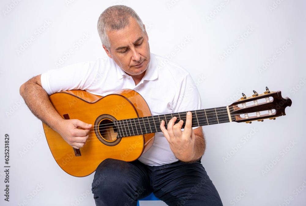 Obraz premium Adult man playing guitar isolated on white background