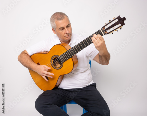 Adult man playing guitar isolated on white background