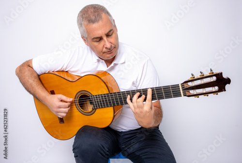 Adult man playing guitar isolated on white background