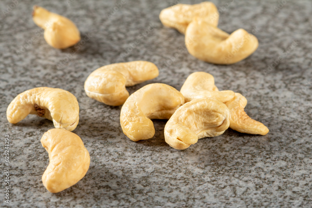A bunch of cashew nuts on a stone stand close-up A bunch of cashew nuts on a stone stand close-up