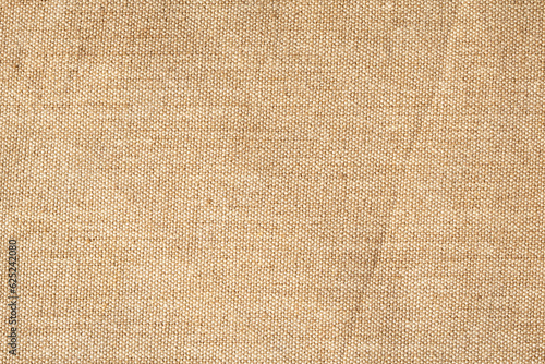 finely textured background of beige linen fabric