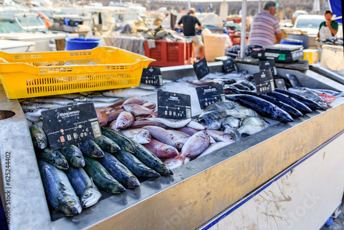 Leinwand Poster Freshly caught fish, mackerel, sea bream and dorade bass on display at the fish