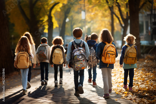 Many High school girls carrying backpacks and walking in a park in autumn, back to school concept