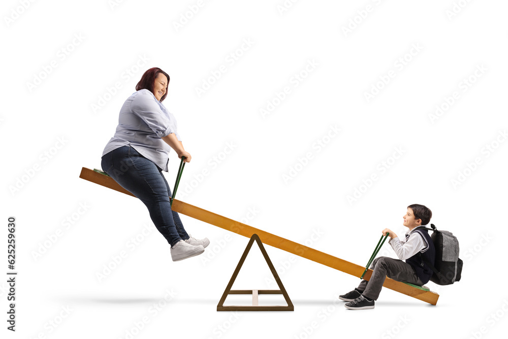 Woman and a schoolboy playing on a seesaw Woman and a schoolboy playing on a seesaw