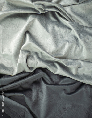 gray velvet with folds, dark and light textile, luxury silk fabric background and copy space