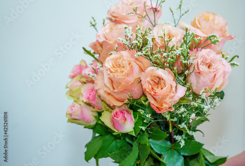 A beautiful luxurious bouquet of mixed flowers lies on the table. Wedding bouquet. Working as a florist in a flower shop
