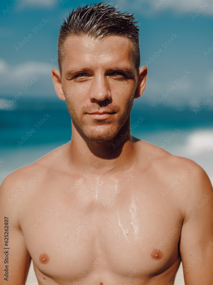 Portrait of attractive man on a tropical beach. Man looking at camera Portrait of attractive man on a tropical beach. Man looking at camera