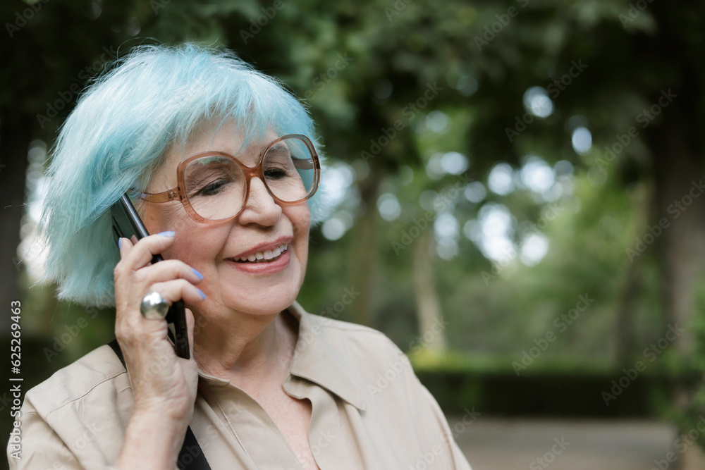older woman outdoors talking on a cell phone older woman outdoors talking on a cell phone