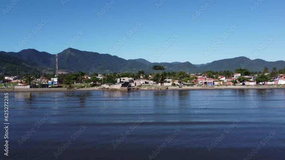 Small coastal village with peaceful beach and beautiful mountains Small coastal village with peaceful beach and beautiful mountains