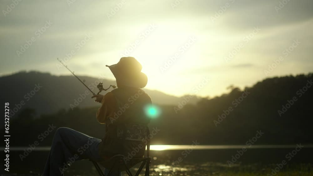 Handsome man fishing as a leisure activity during his vacation and sitting in the lake on sunset. Relax and hobby concept.
Handsome man fishing as a leisure activity during his vacation and sitting in the lake on sunset. Relax and hobby concept.