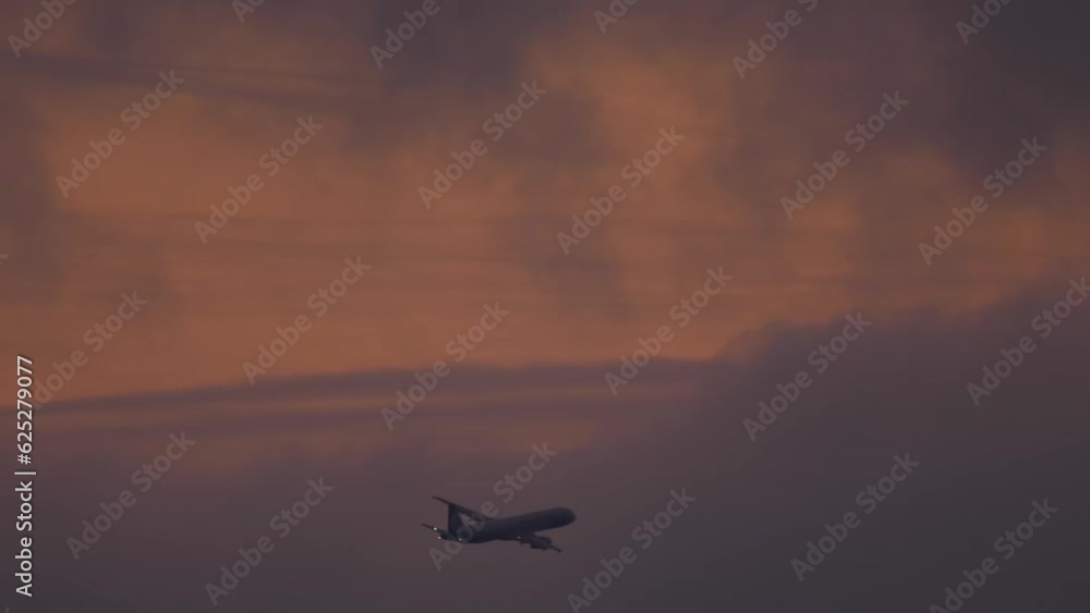 Jet plane flies, silhouette in the night. Airplane leaving. Aircraft fly away. Airliner in the sky Jet plane flies, silhouette in the night. Airplane leaving. Aircraft fly away. Airliner in the sky