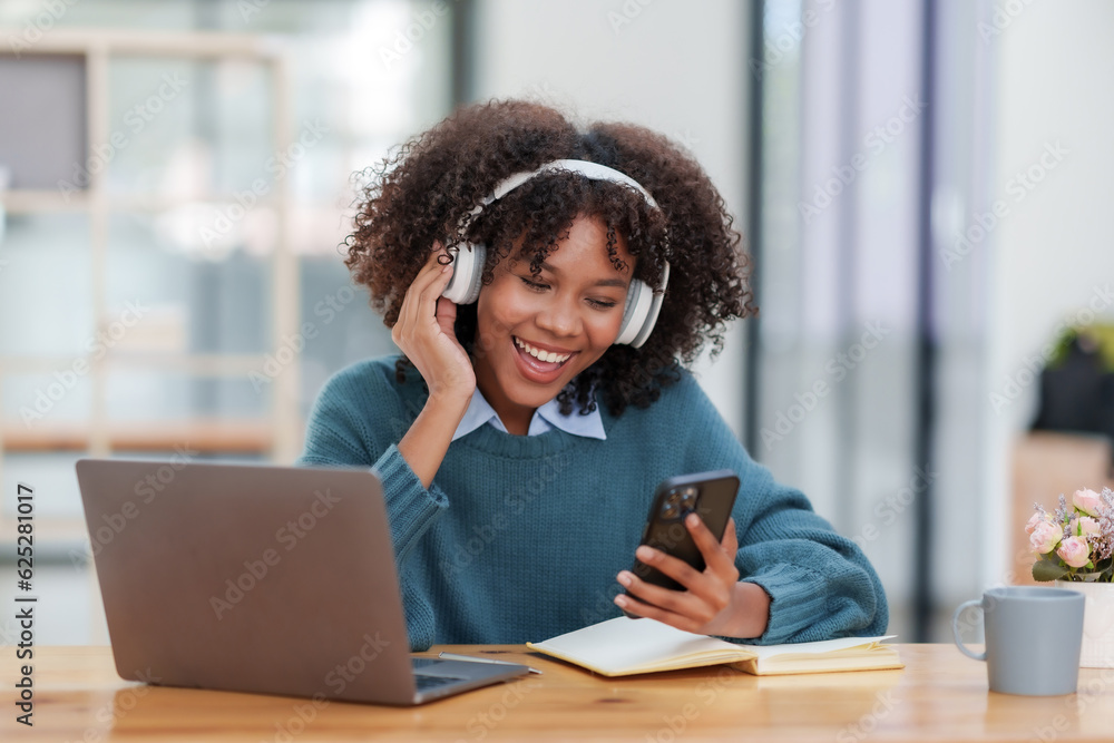 Young black woman curly hair making video call via smart phone talking with friends. Young black woman curly hair making video call via smart phone talking with friends.