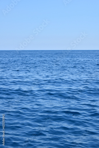 Seascape with water ripples and clear blue sky