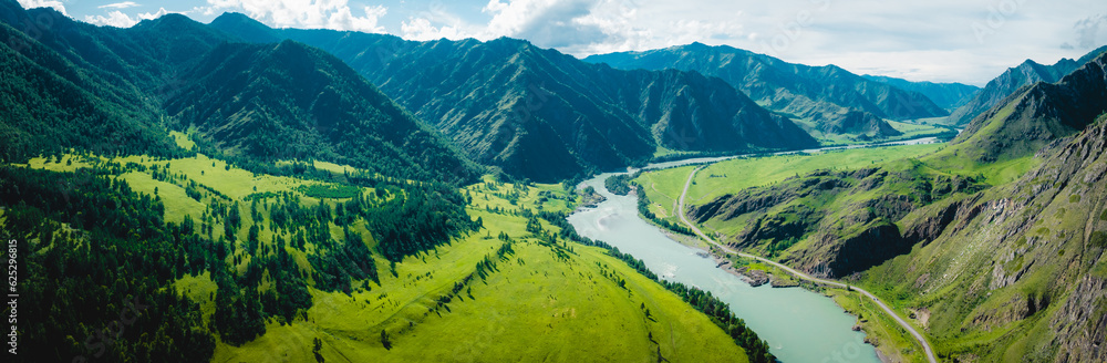 View of the Katun river in the Altai near Chemal. Mountain valley Che-Chkysh. Summer landscape. Turquoise river, mountains and green meadows
