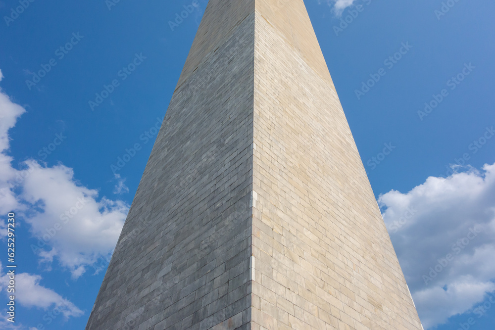 Washington Monument in Washington DC with across from the reflecting pond. Pictures taken  on a sunny summer day with a nice amount of clouds evenly spread out in the sky.