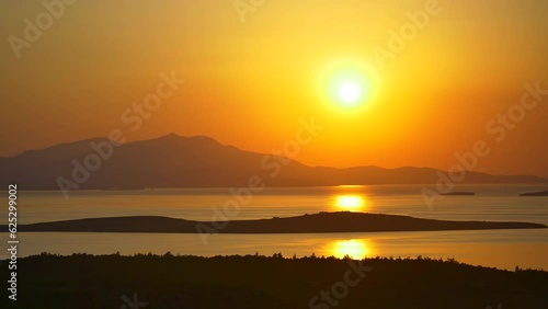 A bright sunset over Aegean Sea. Sundown time at Seytan Sofrasi Ayvalik, Turkey Country. High quality 4K, Camera Original CODEC, No noise
 photo