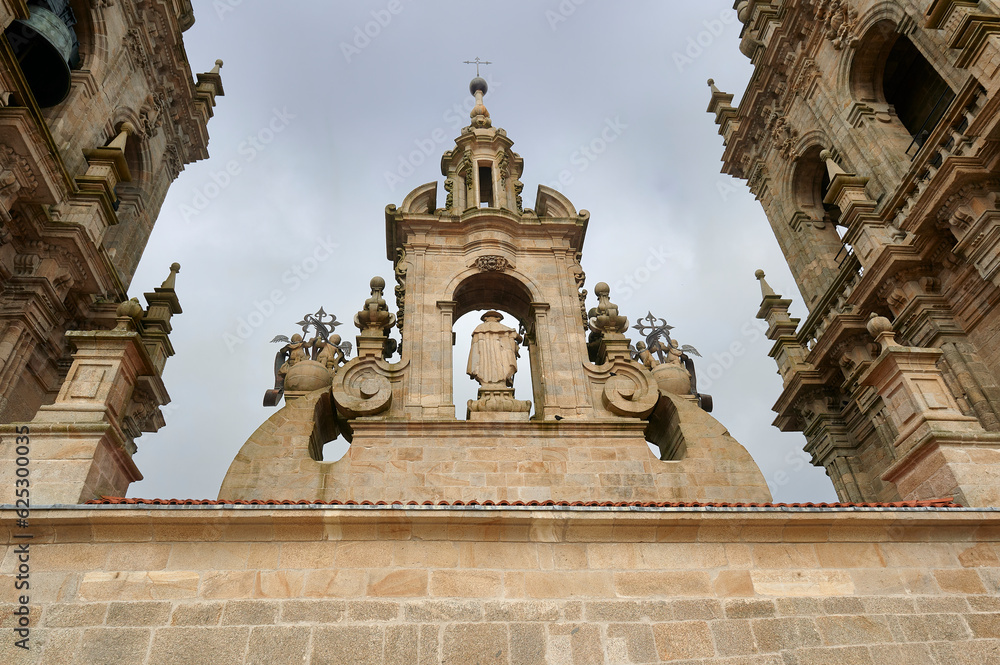 high rear part of the façade of the obradoiro in the cathedral of Santiago de Compostela with the niche where the image of Santiago Pilgrim is flanked by the two bell towers high rear part of the façade of the obradoiro in the cathedral of Santiago de Compostela with the niche where the image of Santiago Pilgrim is flanked by the two bell towers