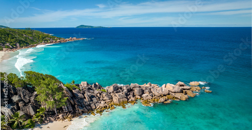 Aerial view of famous Grand Anse beach with big granite rocks on the La Digue island, Seychelles. Tropical landscape with sunny sky. photo