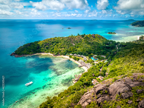 Fototapeta Naklejka Na Ścianę i Meble -  Praslin Seychelles tropical island with withe beaches and palm trees. Aerial view of tropical paradise bay with granite stones and turquoise crystal clear waters of Indian Ocean