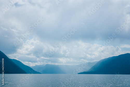 Aerial view of Teletskoye lake in the Altai Mountains in summer. Coniferous forest, blue sky with clouds. Russian siberia scenery. Artybash. Altai Republic photo