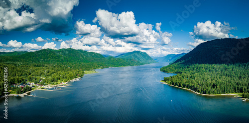 Fototapeta Naklejka Na Ścianę i Meble -  Aerial view of Teletskoye lake in the Altai Mountains in summer. Coniferous forest, blue sky with clouds. Russian siberia scenery. Artybash. Altai Republic