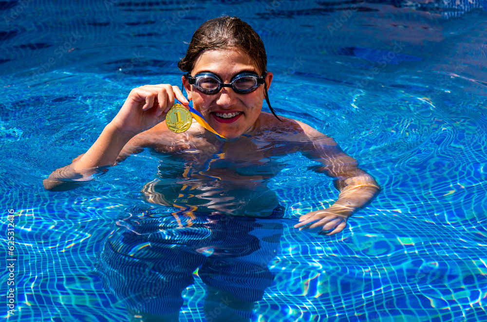 Successful caucasian young swimmer with award in outdoor pool. Golden ...